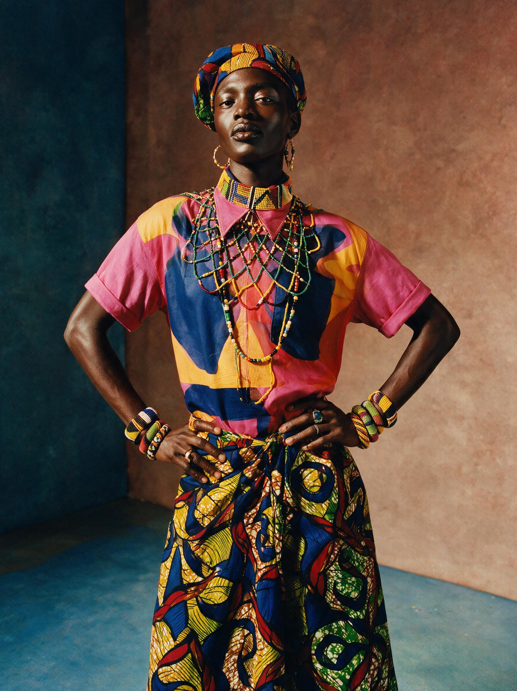 A fashion portrait of a model in a bold print outfit and headwrap